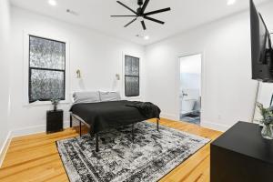 a white bedroom with a bed and a ceiling fan at The Royal Haus NOLA 3 Bed Beauty in New Orleans