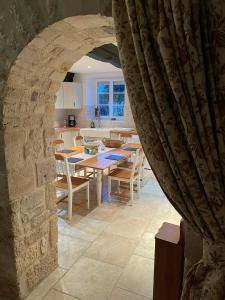 a kitchen and dining room with a table and chairs at The Old Farm Gite in Amfreville