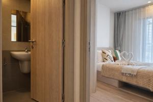 a bathroom with a bed and a sink in a room at Work & Travel in Kathu +10 photos
