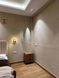 a bedroom with a mirror on a wall next to a bed at SAC HOUSE Sector 41 in Gurgaon