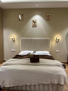 a bedroom with a large bed with a white blanket at SAC HOUSE Sector 41 in Gurgaon
