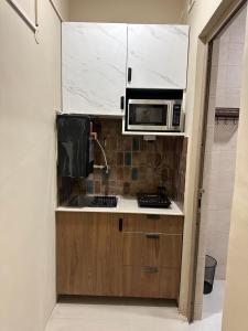 a kitchen with a microwave and a sink at SAC HOUSE Sector 41 in Gurgaon