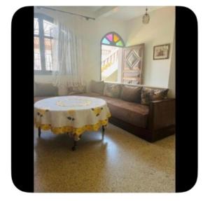 a living room with a couch and a table at Dar Khnata in Temara