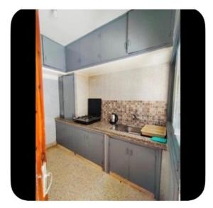 a small kitchen with a sink and a counter at Dar Khnata in Temara