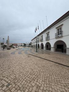 a building with flags on the side of it at Arcada House Tavira in Tavira