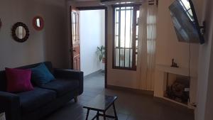 a living room with a couch and a tv at Mirador de Nieva in San Salvador de Jujuy