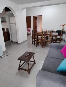 a living room with a couch and a table at Mirador de Nieva in San Salvador de Jujuy