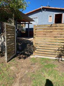 a wooden fence in front of a house at Departamento El Delfín in Tanti