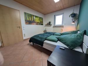 a bedroom with a bed and a table in it at Appartement Sonnenschein in Böhl-Iggelheim