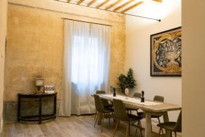 a dining room with a table and chairs at San Giacomo Suites in Città di Castello