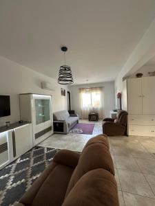 a living room with a couch and a tv at Tala Rivera Paradise in Tala