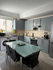 a kitchen with a green table and chairs in it at Tala Rivera Paradise in Tala