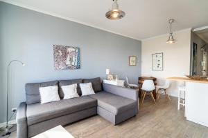 a living room with a gray couch and a table at Barreirinha II Near Old Town With Nice Ocean Views in Funchal