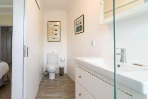 a bathroom with a toilet and a sink at Barreirinha II Near Old Town With Nice Ocean Views in Funchal