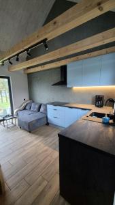 a kitchen with a couch and a table in a room at Domek na Ogrodowej in Tylicz