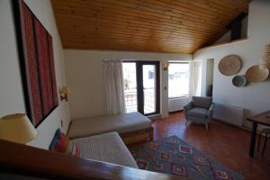 a living room with a couch and a chair at Colorado Apart Hotel in El Colorado