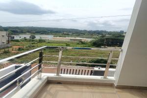 a balcony with a view of a river at Dreamscape Rooms - Yelagiri in Yelagiri
