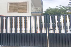 a black fence in front of a house at Dreamscape Rooms - Yelagiri in Yelagiri