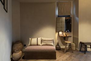 a living room with a couch and a table at WABI-SABI Hôtel Lorrain - Self Check-in in Nice