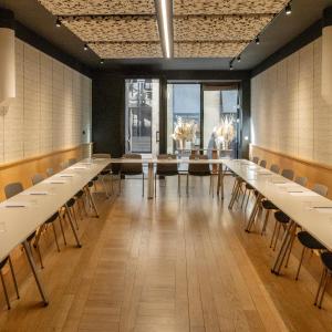 a conference room with long tables and chairs at Grand Hotel Francais in Bordeaux