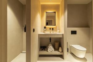 a bathroom with a sink and a toilet at WABI-SABI Hôtel Lorrain - Self Check-in in Nice