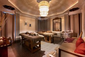 a therapy room with two beds and a couch at Palais Mirage d'Atlas, Hôtel & Spa in Marrakesh +23 photos