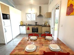 a kitchen with a table with two chairs and a tableablish at Pierron in Linxe +16 photos