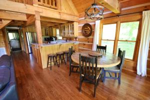 a dining room with a table and chairs in a cabin at The Meadows in Cherokee