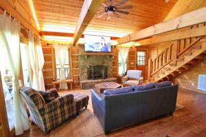 a living room with a couch and a fireplace at The Meadows in Cherokee