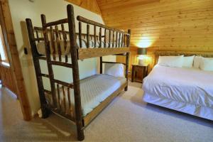 a bedroom with two bunk beds in a cabin at The Meadows in Cherokee