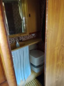 a small bathroom with a sink and a toilet at Autocaravana in Port Saplaya +5 photos