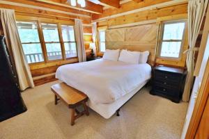 a bedroom with a large bed in a wooden cabin at The Highland in Cherokee