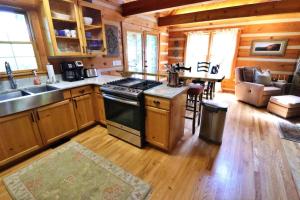 a kitchen with a stove and a sink in a cabin at The Oakes in Cherokee +22 photos
