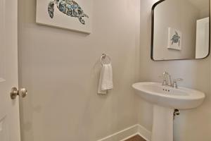 a white bathroom with a sink and a mirror at Rooftop Balcony with River View in SoKnox in Knoxville +20 photos