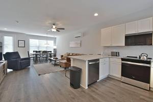 an open kitchen and living room with a dining room at Rooftop Balcony with River View in SoKnox in Knoxville