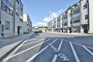 an empty street with a car parked in front of buildings at Rooftop Balcony with River View in SoKnox in Knoxville