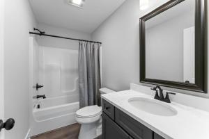a bathroom with a sink and a toilet and a mirror at McCormick Retreat in Knoxville