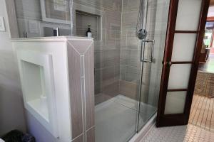 a bathroom with a shower with a glass door at The Nama Retreat 201 - Renovated Downtown Loft near Gay St | Walk Everywhere in Knoxville