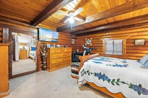 a bedroom with a bed in a log cabin at Kingman Cabin in Kingman