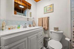 a white bathroom with a toilet and a sink at Kingman Cabin in Kingman +28 photos