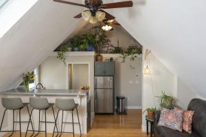 a kitchen and living room with a ceiling fan at The Garden House in Saco