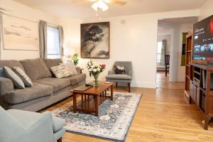 a living room with a couch and a table at The Garden House in Saco