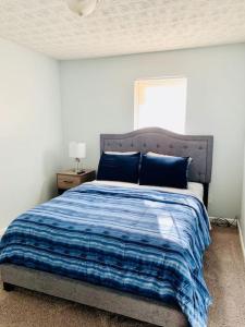 a bedroom with a bed with a blue blanket at Covington Station Escape in Lithonia