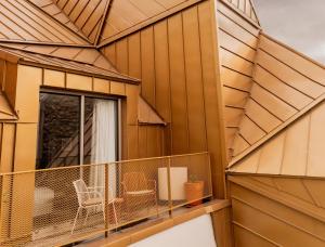 a building with a balcony with chairs on it at Hôtel Pilgrim in Paris +68 photos