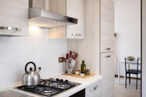 a kitchen with a stove and a tea kettle at Lake Como Lilla Apartment in Oliveto Lario