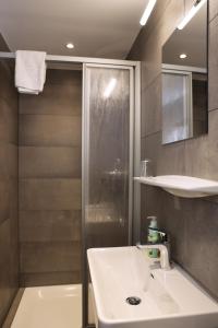 a bathroom with a sink and a shower at Hotel Garni Post in Grainau +101 photos