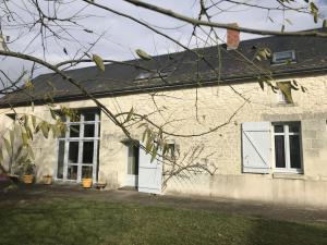 a white brick house with a white door at Le pin de la tour in Sossais
