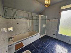 a bathroom with a tub and a shower and a sink at Le pin de la tour in Sossais +16 photos