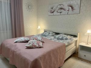a bedroom with a bed with two pillows on it at Lake Suite Family in Lahti