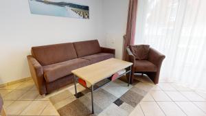 a living room with a couch and a table at Appartementhaus Binzer Sterne 09 in Binz